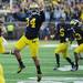 Michigan kicker Brendan Gibbons jumps in the air as the team rushes the field after beating Northwestern 38-31 in overtime at Michigan Stadium on Saturday. Melanie Maxwell I AnnArbor.com